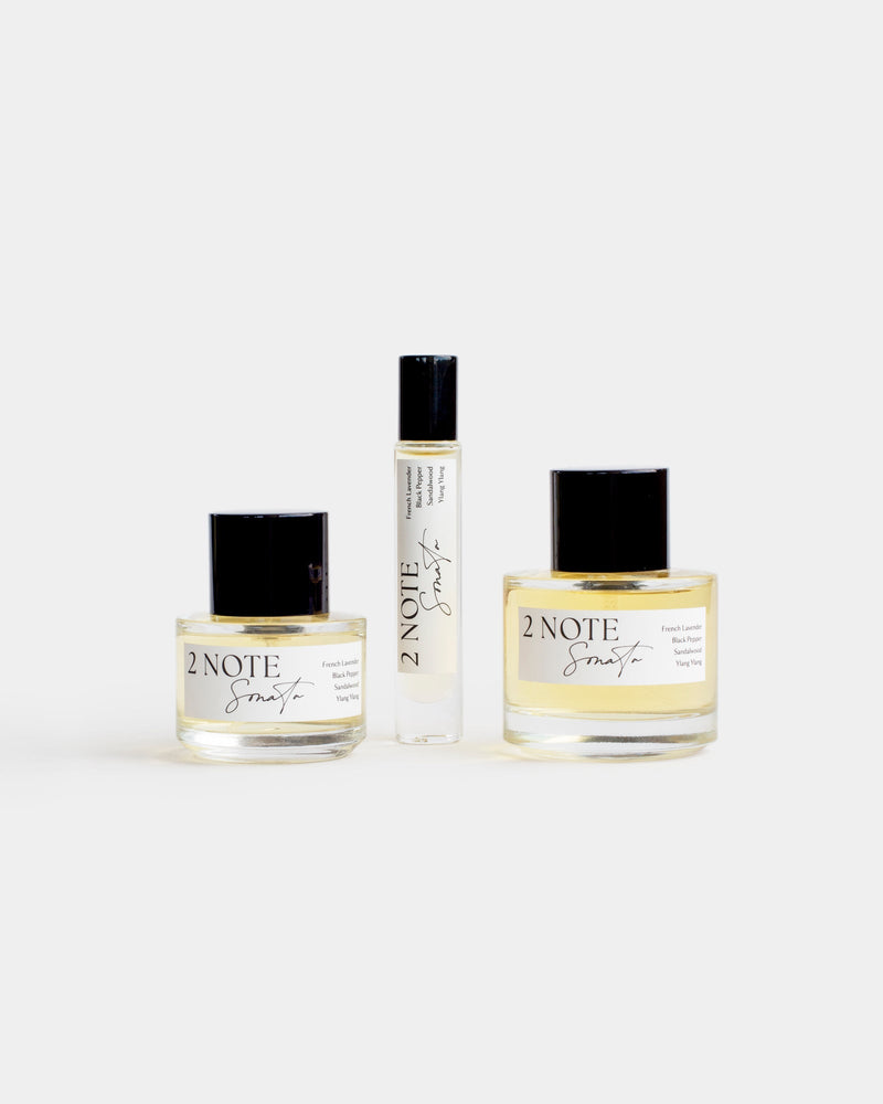 Sonata botanical fragrance in three sizes — small and large spray bottles and a roller, pale yellow oil through clear glass