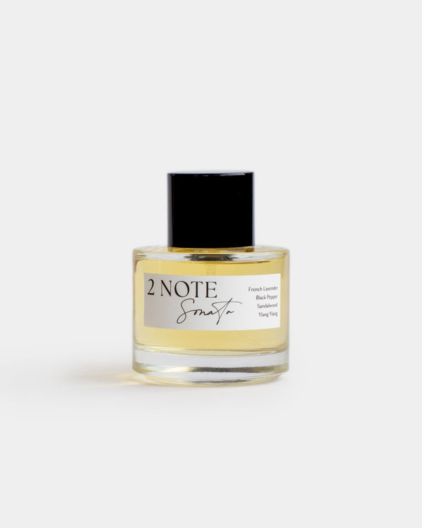 Sonata in clear glass spray bottle — botanical natural fragrance, pale soft yellow oil, front view on white