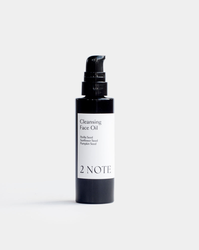Cleansing Face Oil in matte black pump bottle — botanical natural skincare face cleanser with Perilla Seed, Sunflower Seed, and Pumpkin Seed, front view on white