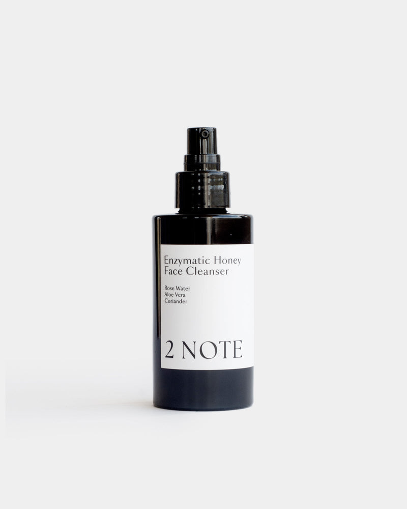 Enzymatic Honey Face Cleanser in matte black spray bottle — botanical natural skincare cleanser with Rose Water, Aloe Vera, and Coriander, front view on white