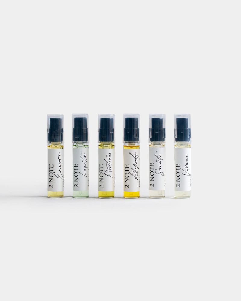 Fragrance Sample Set — six botanical fragrance Composition spray vials in a row on light gray: Encore, Legato, Nocturne, Rhapsody, Sonata, and Vivace
