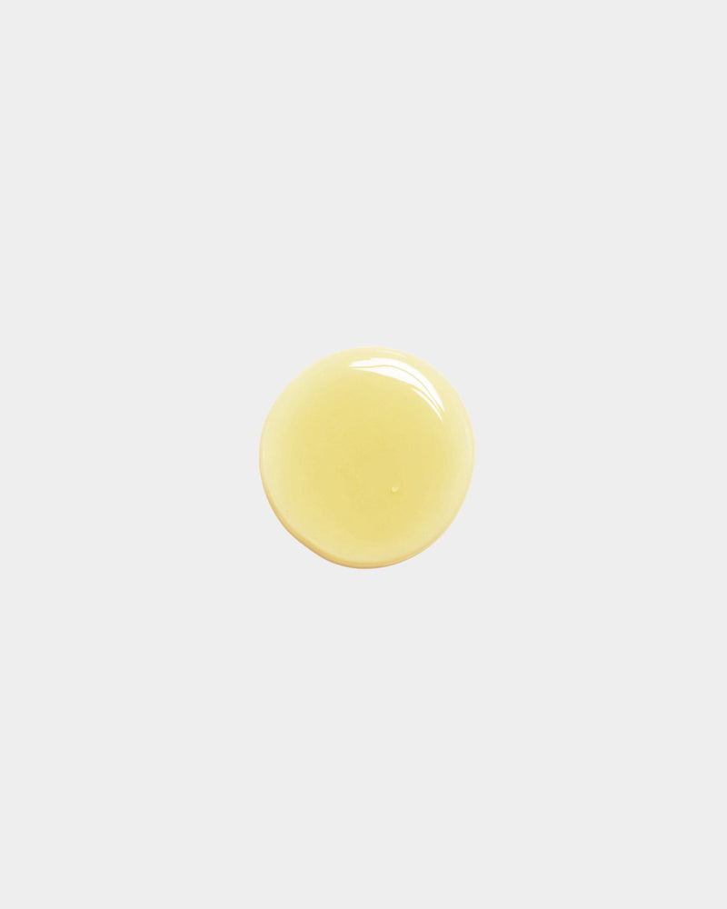 Cleansing Face Oil formula swatch — single pale yellow botanical oil drop on white surface