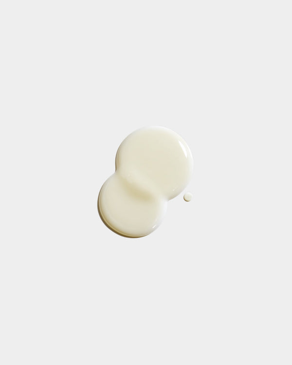 Hand Soap formula swatch — two overlapping cream-white botanical skincare liquid drops on light gray surface