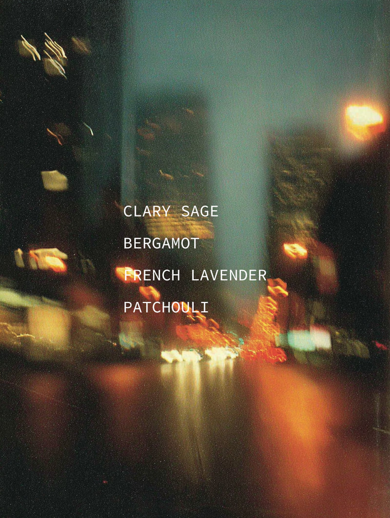 Blurred night city street with traffic light trails — mood portrait for Legato botanical fragrance with Clary Sage, Bergamot, French Lavender, and Patchouli