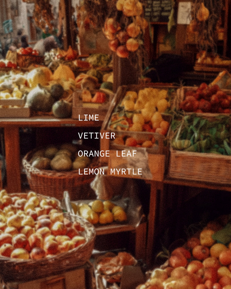 Colorful outdoor fruit and citrus market stall — mood portrait for Vivace botanical fragrance with Lime, Vetiver, Orange Leaf, and Lemon Myrtle