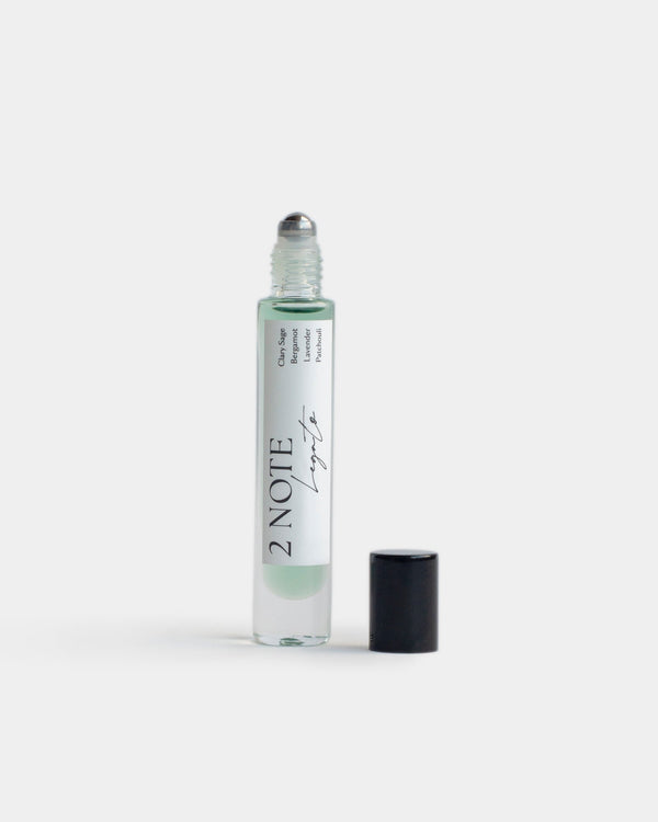Legato in tall clear glass roller bottle — botanical fragrance oil, emerald green, uncapped