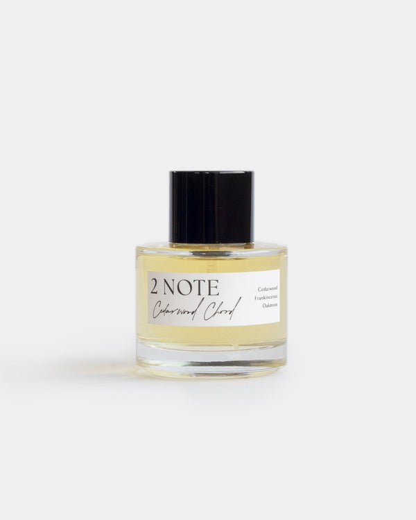 Cedarwood Chord in clear glass spray bottle — single-note botanical fragrance, pale yellow oil, front view on white