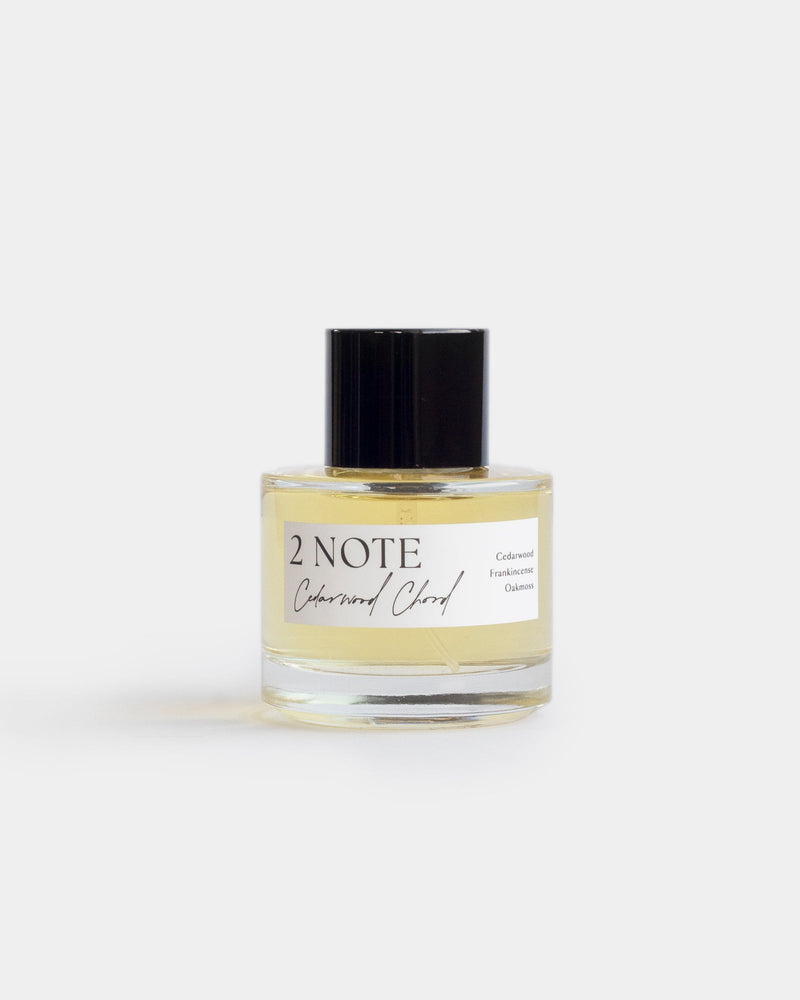 Cedarwood Chord in clear glass spray bottle — single-note botanical fragrance, pale yellow oil, front view on white