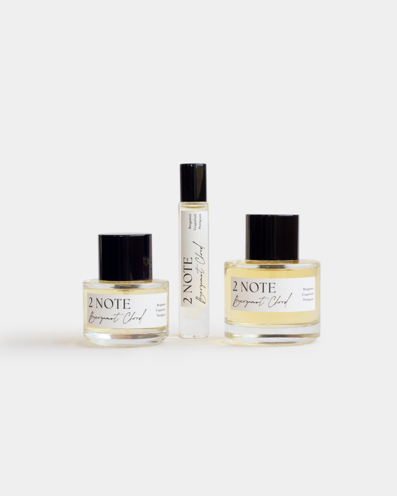 Bergamot Chord botanical fragrance in three sizes — small and large spray bottles and a roller, pale yellow oil through clear glass