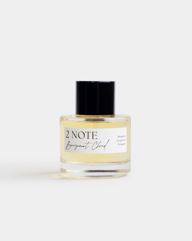 Bergamot Chord in clear glass spray bottle — single-note botanical fragrance, pale yellow oil, front view on white