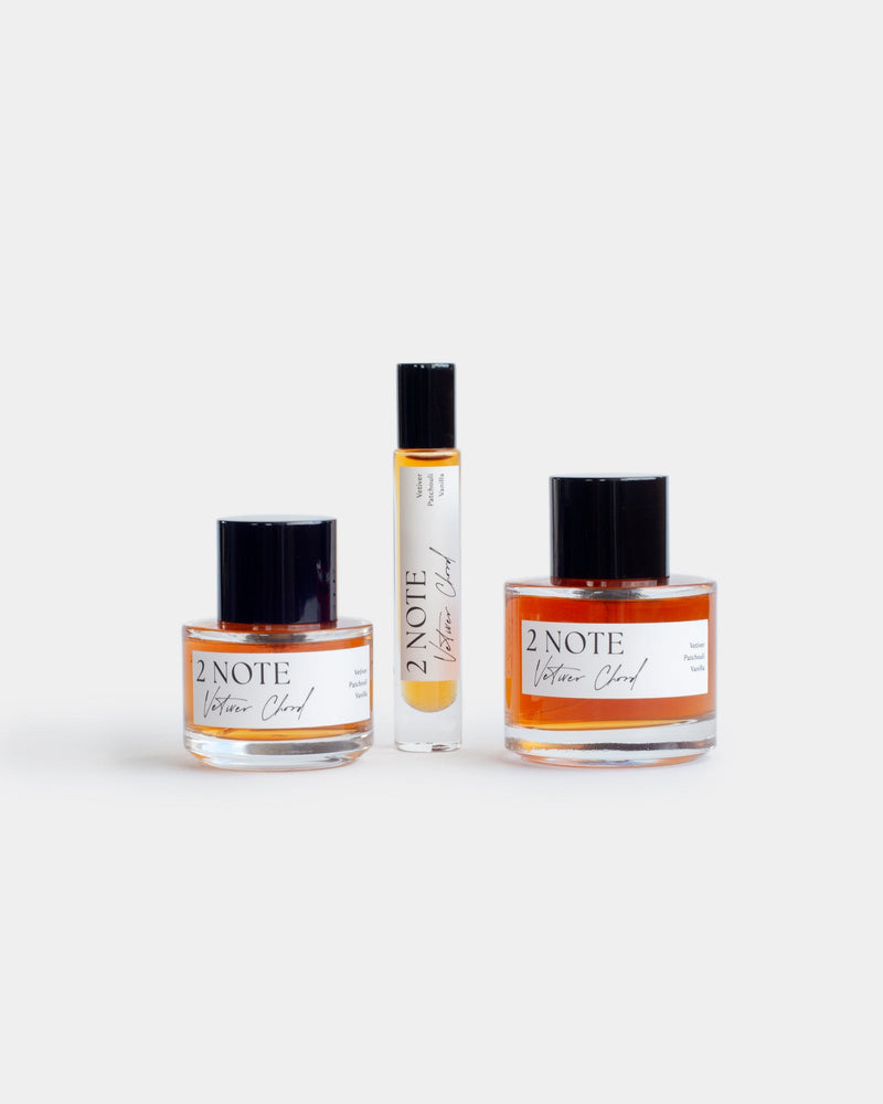 Vetiver Chord botanical fragrance in three sizes — small and large spray bottles and a roller, amber oil through clear glass