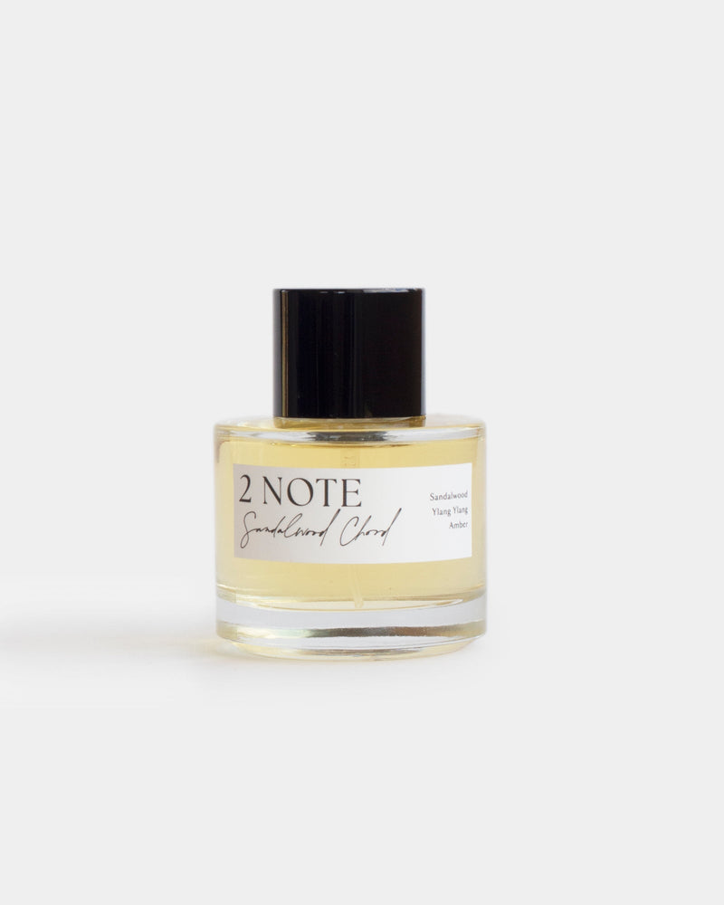 Sandalwood Chord in clear glass spray bottle — single-note botanical fragrance, pale straw oil, front view on white