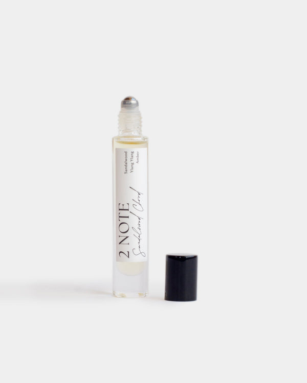 Sandalwood Chord in tall clear glass roller bottle — botanical natural fragrance oil, pale straw, uncapped