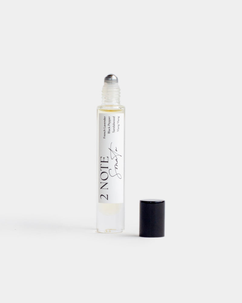 Sonata in tall clear glass roller bottle — botanical fragrance oil, pale yellow, uncapped