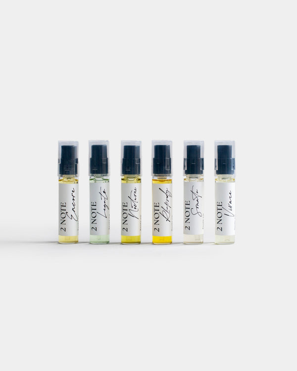 Fragrance Sample Set — six botanical fragrance Composition spray vials in a row on light gray: Encore, Legato, Nocturne, Rhapsody, Sonata, and Vivace