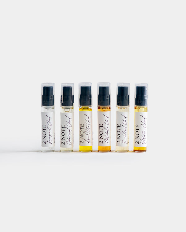 Fragrance Sample Set — six botanical fragrance Chord single-note spray vials in a row on light gray, oils ranging from clear to deep amber