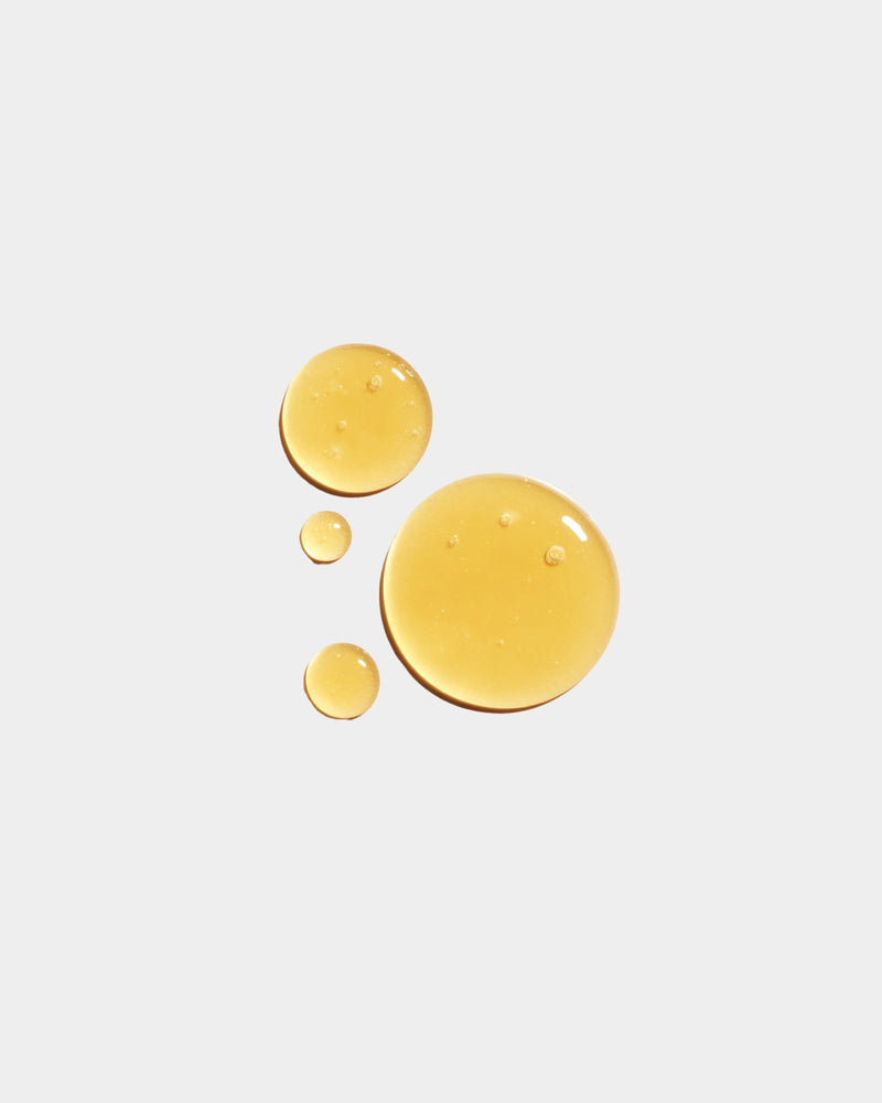 Honey Face Cleanser formula swatch — warm amber honey-colored liquid drops on white surface