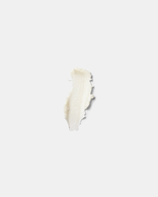 Lip Balm formula swatch — white wax-and-butter balm smear on white surface