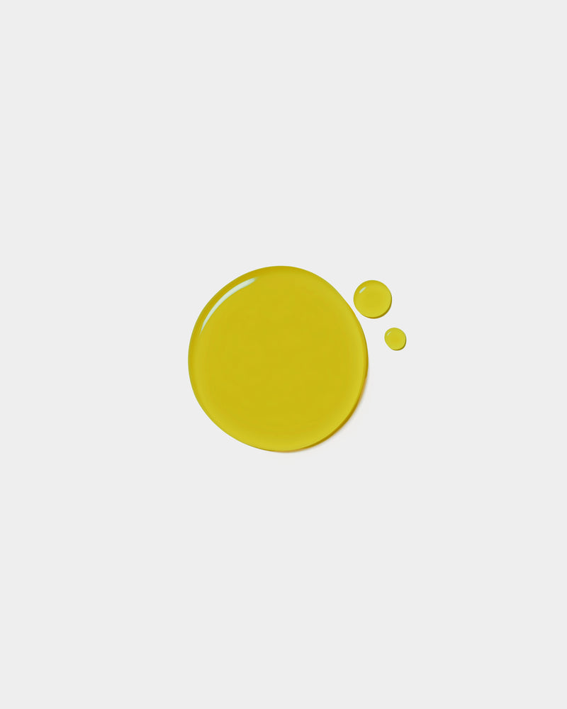 Nourishing Face Oil formula swatch — vivid olive green botanical oil drop on white surface
