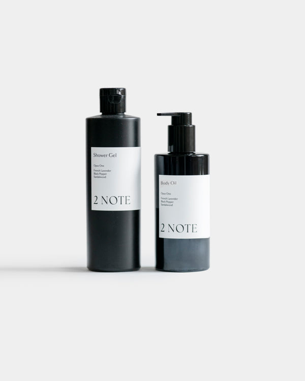 The Body Duo Set — Shower Gel and Body Oil matte black bottles side by side on light gray, botanical skincare shower and body ritual